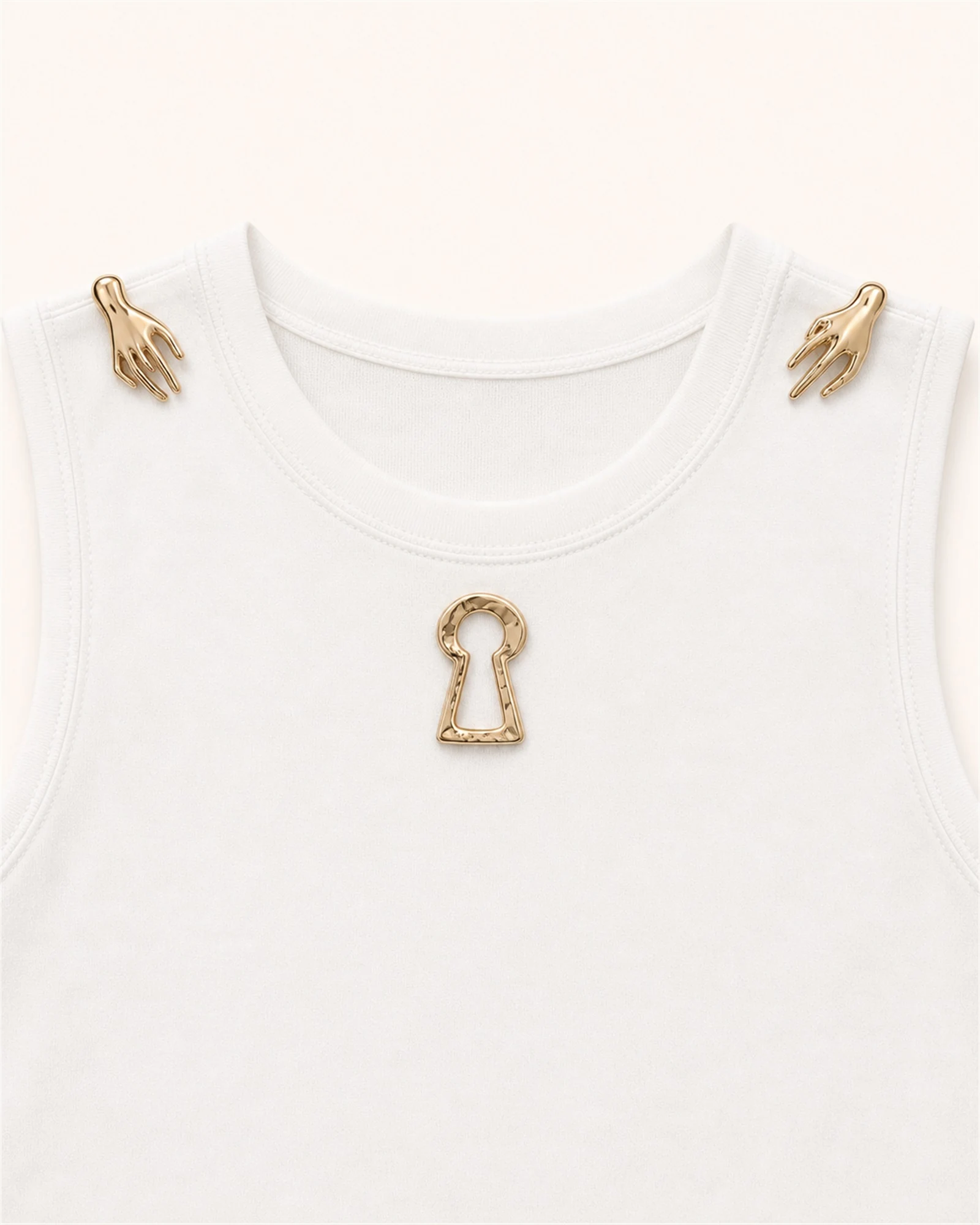 Close-up of gold hand shoulder hardware and keyhole chest embellishment