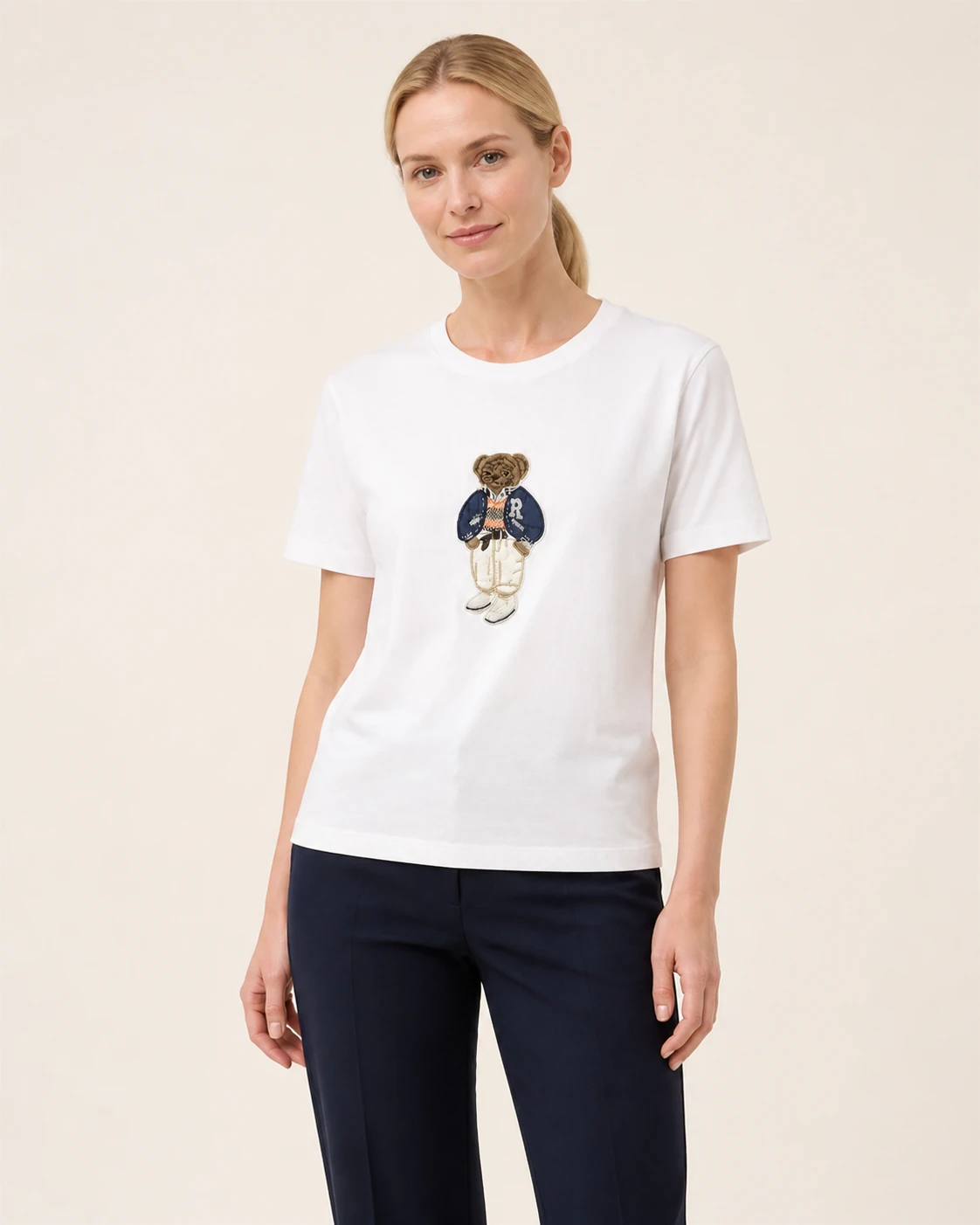 Model wearing the white VTTS-0023 varsity bear embroidered T-shirt