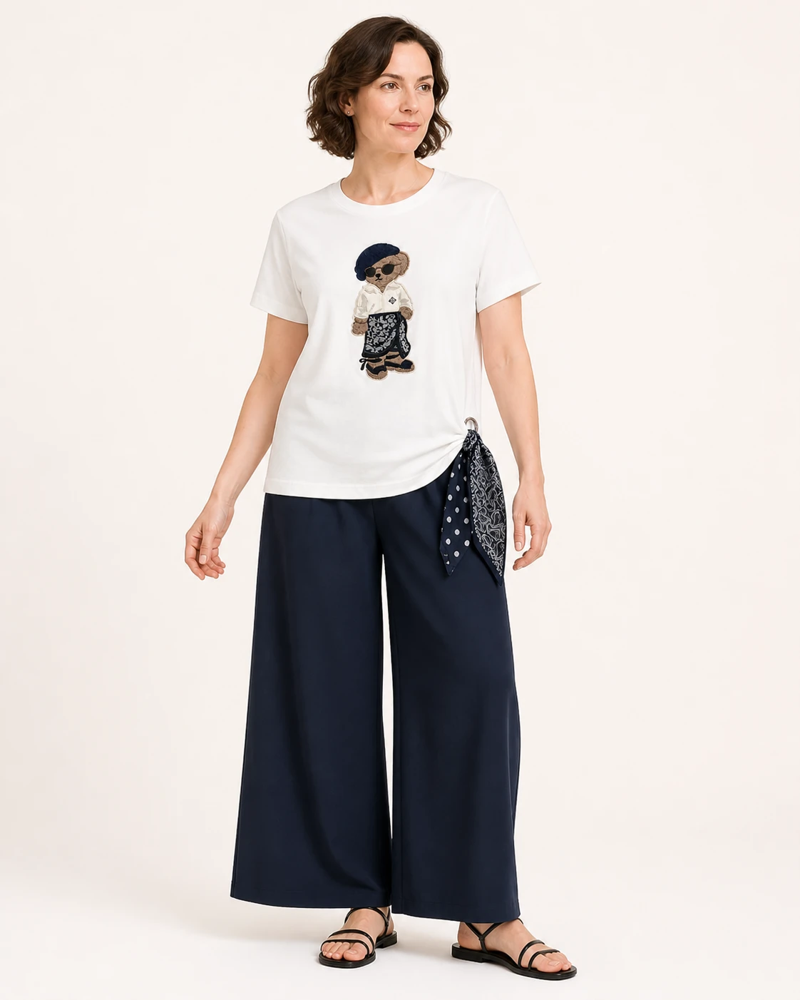 Custom Women's Bandana Bear Embroidered Side-Tie T-Shirt — VTTS-0026 Model wearing the white VTTS-0026 bandana bear embroidered T-shirt