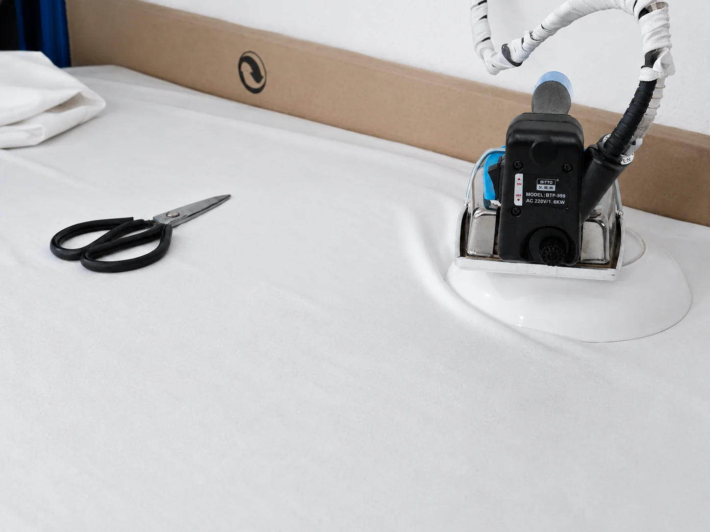 About Vanty Garment — Women’s Apparel Manufacturer Electric fabric cutting tool on a sample-room cutting table