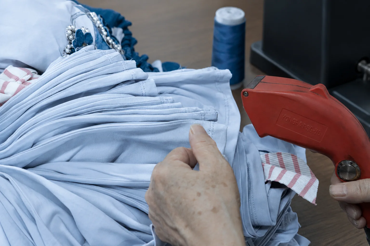 About Vanty Garment — Women’s Apparel Manufacturer Blue garments being prepared during the finishing process