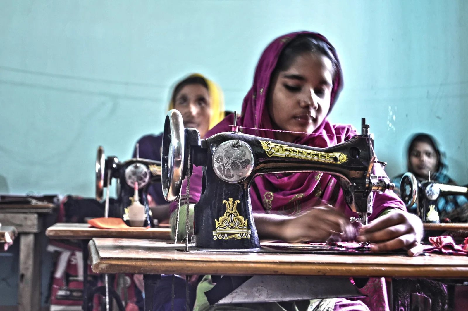 Women’s T-Shirt Sampling and Development Garment maker operating a sewing machine during sample development