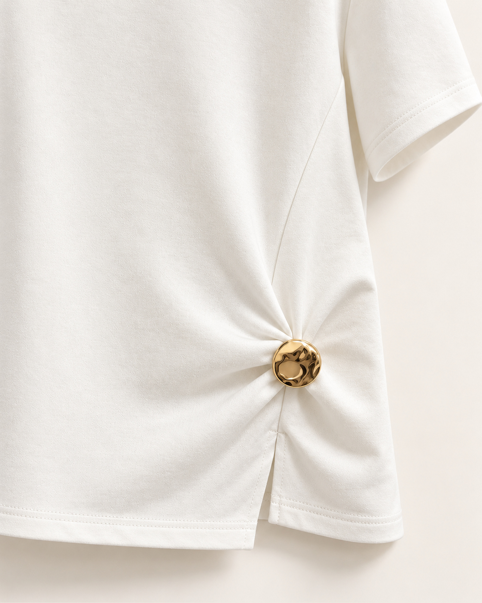 Close-up of the side-gathered hem finished with a gold-tone ornament on VTTS-0047