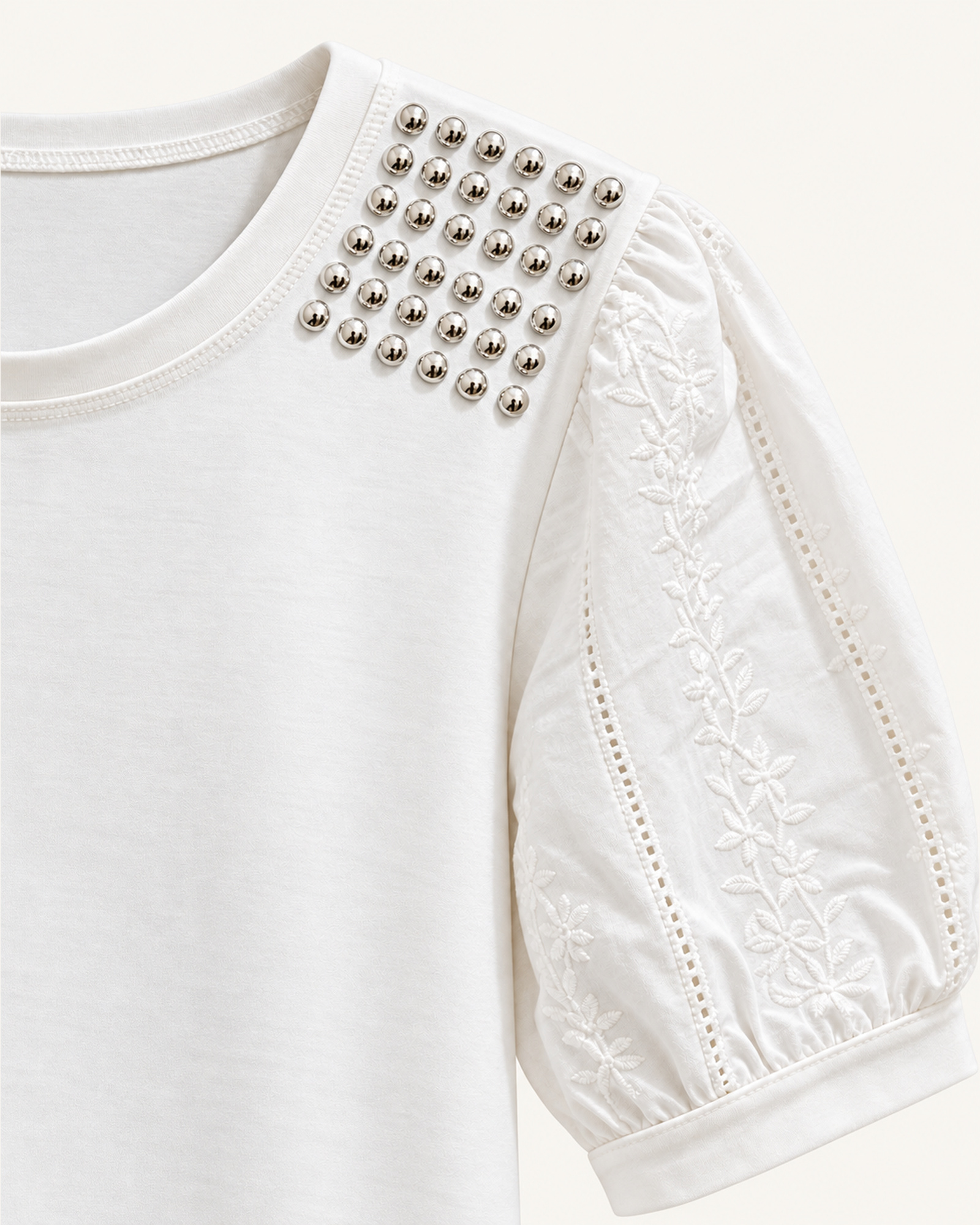 Close-up of the eyelet puff sleeves with square embellished shoulder panels on VTTS-0051