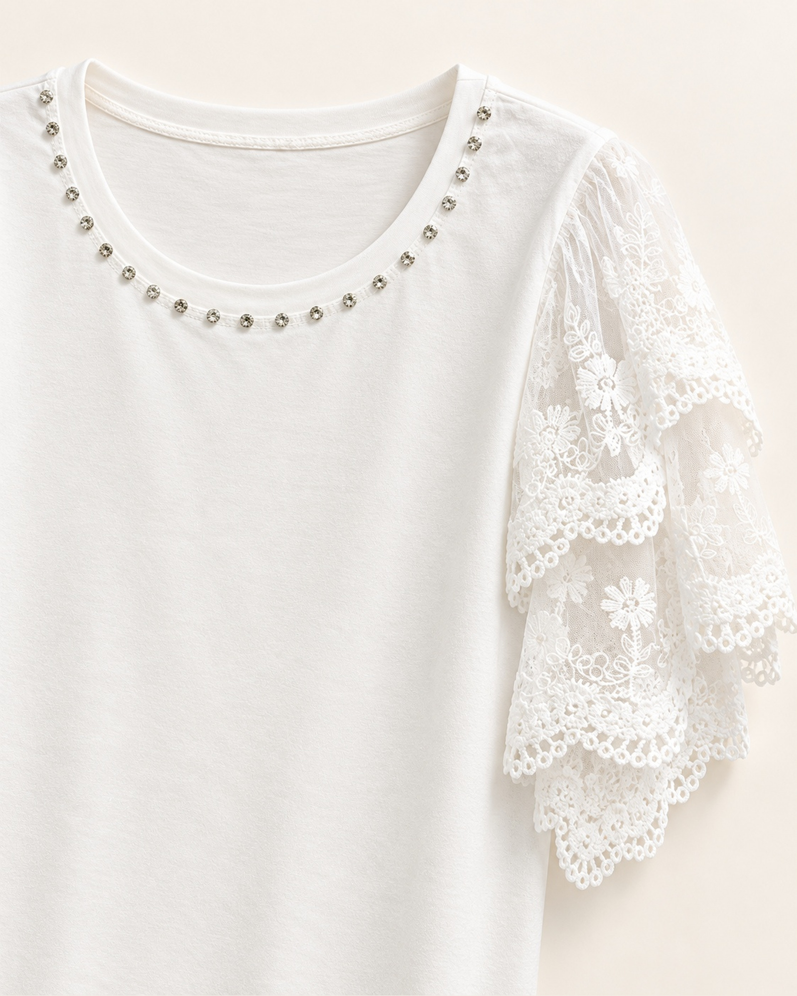 Close-up of the scalloped eyelet lace sleeves and stud trim around the neckline on VTTS-0056